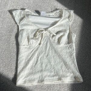 Creamy white lace top with bow detail